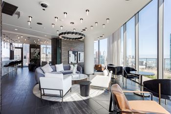 A modern living room with a large window overlooking the city.